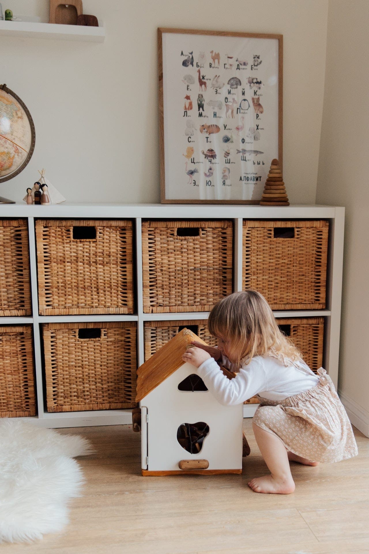 girl-playing-with-a-wooden-toy-house girl playing in her clean room