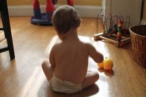 Baby playing on the floor in a clean and disinfectant room