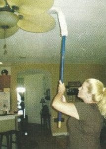 christine cleaning an overhead fan