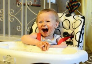 baby eating in a highchair